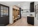 Inviting entryway featuring a modern mudroom bench, wood floors, and ample storage at 3803 S Elm St, Tempe, AZ 85282