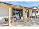 Inviting covered porch featuring contemporary furniture and natural wood accents with a view of the front yard at 3803 S Elm St, Tempe, AZ 85282