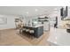 Stylish kitchen island with bar seating, modern white cabinetry, and a view of the dining area at 3803 S Elm St, Tempe, AZ 85282