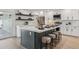 Modern kitchen island featuring bar seating, sleek countertops, and stylish decor with stainless steel appliances at 3803 S Elm St, Tempe, AZ 85282