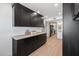 Laundry room with black cabinets and butcher block countertops offering both style and functionality at 3803 S Elm St, Tempe, AZ 85282