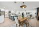 Open living space showcasing a modern kitchen island, dining area, and seamless flow into the living room at 3803 S Elm St, Tempe, AZ 85282