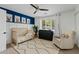 Bedroom with a crib, accent wall, and a comfortable rocking chair at 3922 E Elm St, Phoenix, AZ 85018