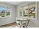 Bright breakfast nook with table and chairs, hardwood floors, and big windows with views of the outdoor space at 3922 E Elm St, Phoenix, AZ 85018