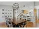 Open concept dining room with wood floors and kitchen view. Includes a large wood table and industrial light fixture at 3922 E Elm St, Phoenix, AZ 85018