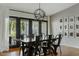 Dining room features a large wood table, black chairs, a modern light fixture, and large windows with a backyard view at 3922 E Elm St, Phoenix, AZ 85018