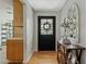 Light and airy foyer with hardwood floors, decor mirror and a black front door at 3922 E Elm St, Phoenix, AZ 85018