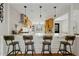 Kitchen island with seating, wood cabinets, and white countertops in a modern space, perfect for casual dining at 3922 E Elm St, Phoenix, AZ 85018