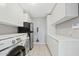 Bright laundry room featuring white cabinetry, sleek appliances, and efficient organization at 3922 E Elm St, Phoenix, AZ 85018