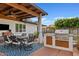 Inviting outdoor dining area featuring a ceiling fan, a built-in grill, and a cozy atmosphere at 3922 E Elm St, Phoenix, AZ 85018