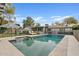 Swimming pool with an umbrella, lounge chairs, and a well-manicured backyard perfect for outdoor enjoyment at 3922 E Elm St, Phoenix, AZ 85018