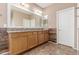 Bathroom with a large vanity featuring double sinks, granite countertops, and a full-width mirror at 4033 S Harlan --, Mesa, AZ 85212