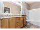 Bathroom featuring double sinks, granite countertops, and a shower/bathtub combination with tiled walls at 4033 S Harlan --, Mesa, AZ 85212