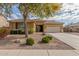 Charming single-story home featuring a well-maintained front yard and a two-car garage at 4033 S Harlan --, Mesa, AZ 85212