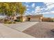 Charming single-story home featuring a well-maintained front yard with desert landscaping and a two-car garage at 4033 S Harlan --, Mesa, AZ 85212