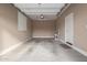 Spacious empty garage with concrete floors, neutral walls, and overhead lighting fixtures at 4033 S Harlan --, Mesa, AZ 85212