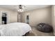 Neutral bedroom boasts carpet flooring, ceiling fan and direct access to the ensuite bathroom and walk-in closet at 4040 E Rowel Rd, Phoenix, AZ 85050