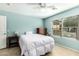 Cozy bedroom featuring natural light, tile flooring, ceiling fan, and a wooden dresser at 4040 E Rowel Rd, Phoenix, AZ 85050