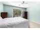 Bedroom with tile floor features a window and ceiling fan for added comfort at 4040 E Rowel Rd, Phoenix, AZ 85050