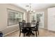 Dining room featuring a window, chandelier, and a sliding glass door at 4040 E Rowel Rd, Phoenix, AZ 85050