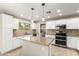 Bright kitchen featuring white cabinets, granite countertops, and stainless steel appliances at 4040 E Rowel Rd, Phoenix, AZ 85050