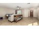 Spacious living room featuring tile floors, neutral walls, and a ceiling fan at 4040 E Rowel Rd, Phoenix, AZ 85050