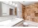 Stylish bathroom with a travertine-tiled shower and a marble sink at 4622 N 78Th St, Scottsdale, AZ 85251