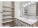 Bright bathroom features a sink with a marble countertop and a mirrored vanity at 4622 N 78Th St, Scottsdale, AZ 85251