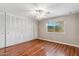 Spacious bedroom with hardwood floors, a ceiling fan, and a window that lets in plenty of natural light at 4622 N 78Th St, Scottsdale, AZ 85251