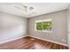 Bright bedroom featuring hardwood floors, a ceiling fan, and a window offering plenty of natural light at 4622 N 78Th St, Scottsdale, AZ 85251