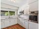 Bright kitchen features white cabinetry, stainless steel appliances, and a large window with natural light at 4622 N 78Th St, Scottsdale, AZ 85251