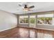 Bright living room with hardwood floors, a ceiling fan, and three large windows offering view to exterior at 4622 N 78Th St, Scottsdale, AZ 85251