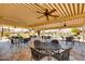 Spacious outdoor seating area with fans, tables and chairs for residents to gather and enjoy at 4622 N 78Th St, Scottsdale, AZ 85251