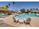 Inviting community pool with lounge chairs, tables, and lush landscaping creates a relaxing outdoor space at 4622 N 78Th St, Scottsdale, AZ 85251