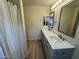 Bathroom featuring a dual sink vanity, wood-look tile flooring and a shower/tub combo at 4757 E Amber Sun Dr, Cave Creek, AZ 85331