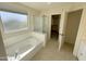 Bathroom featuring an undermount sink, tile flooring, and a bathtub next to a frosted window at 4757 E Amber Sun Dr, Cave Creek, AZ 85331