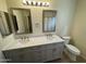 Bathroom with a double sink vanity, framed mirrors and a tiled countertop at 4757 E Amber Sun Dr, Cave Creek, AZ 85331