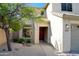 Close up of front of home with appealing landscaping, and a red front door beneath a covered porch at 4757 E Amber Sun Dr, Cave Creek, AZ 85331