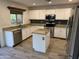 A well-lit kitchen features white cabinets, granite countertops, an island, and stainless steel appliances at 4757 E Amber Sun Dr, Cave Creek, AZ 85331