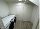 Well-lit laundry room featuring a side-by-side washer and dryer set and gray wood-look flooring at 4757 E Amber Sun Dr, Cave Creek, AZ 85331