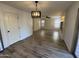 Open-concept living area with wood-look tile flooring and neutral walls, featuring modern lighting and a view to other spaces at 4757 E Amber Sun Dr, Cave Creek, AZ 85331