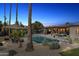 Inviting backyard pool and patio area with an umbrella and landscaped surroundings, perfect for relaxation and outdoor entertainment at 5401 E Corrine Dr, Scottsdale, AZ 85254