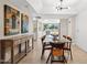 Open-concept dining room with unique lighting fixture, tile floors, and view to the kitchen at 5401 E Corrine Dr, Scottsdale, AZ 85254