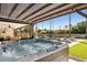 Outdoor hot tub on a patio overlooking a pool, outdoor seating, and lush landscaping at 5401 E Corrine Dr, Scottsdale, AZ 85254