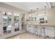 Kitchen with bar seating, stainless steel appliances, and a view of the backyard pool at 5401 E Corrine Dr, Scottsdale, AZ 85254