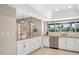 Spacious kitchen featuring white cabinetry, granite counters, and stainless steel appliances at 5401 E Corrine Dr, Scottsdale, AZ 85254