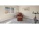 Cozy living room area with comfortable armchair, ottoman and natural light from the window at 5401 E Corrine Dr, Scottsdale, AZ 85254