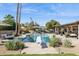 Backyard pool area with mature landscaping, diving board, cabana and outdoor kitchen at 5401 E Corrine Dr, Scottsdale, AZ 85254