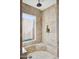 Walk-in shower featuring decorative tile accents, window, and built-in bench at 5401 E Corrine Dr, Scottsdale, AZ 85254