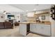 Elegant wet bar adjacent to the living room, complete with granite countertops and a wine fridge at 5401 E Corrine Dr, Scottsdale, AZ 85254